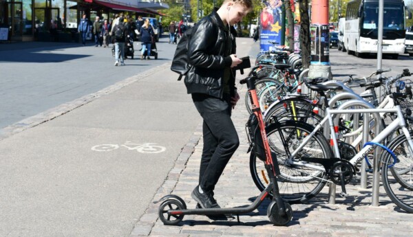 En person vid en elsparkcykel i stan