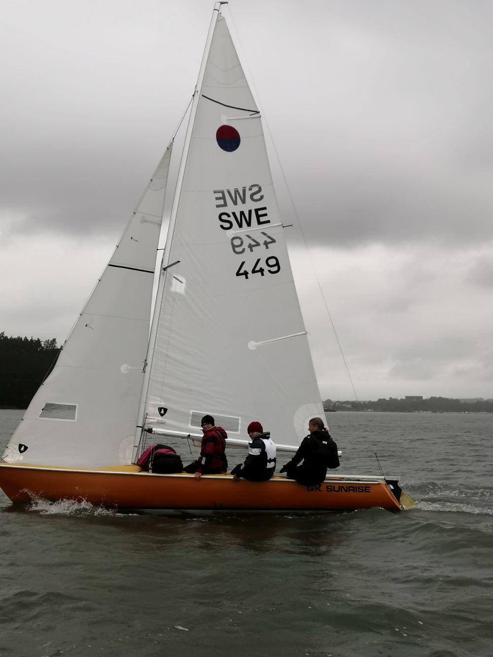 en segelbåt med besättning på havet