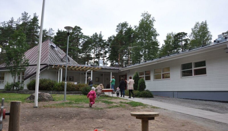 barn och vuxna som springer in från en gård, Daghemmet Karusellen i nagu