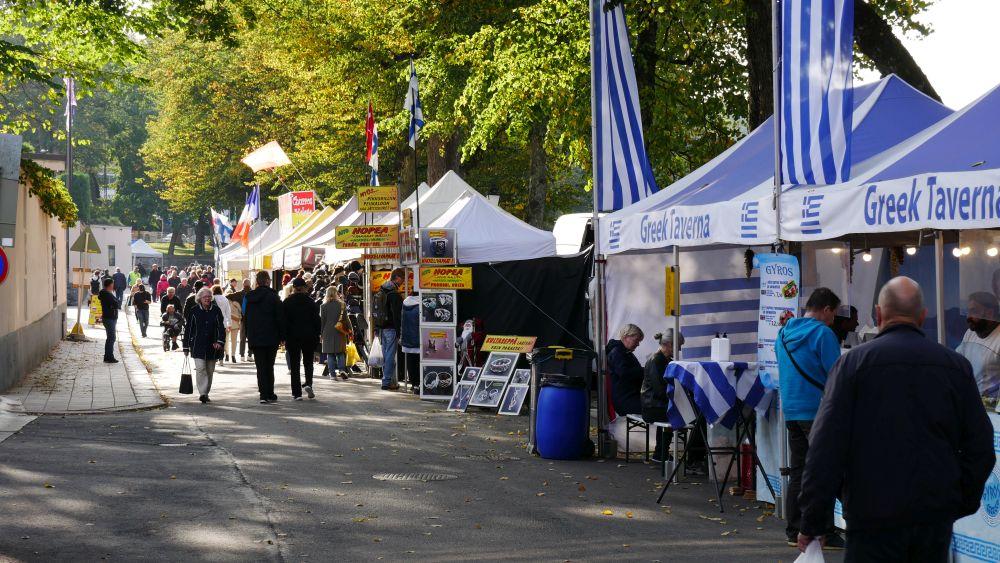 folk går på marknad i solsken