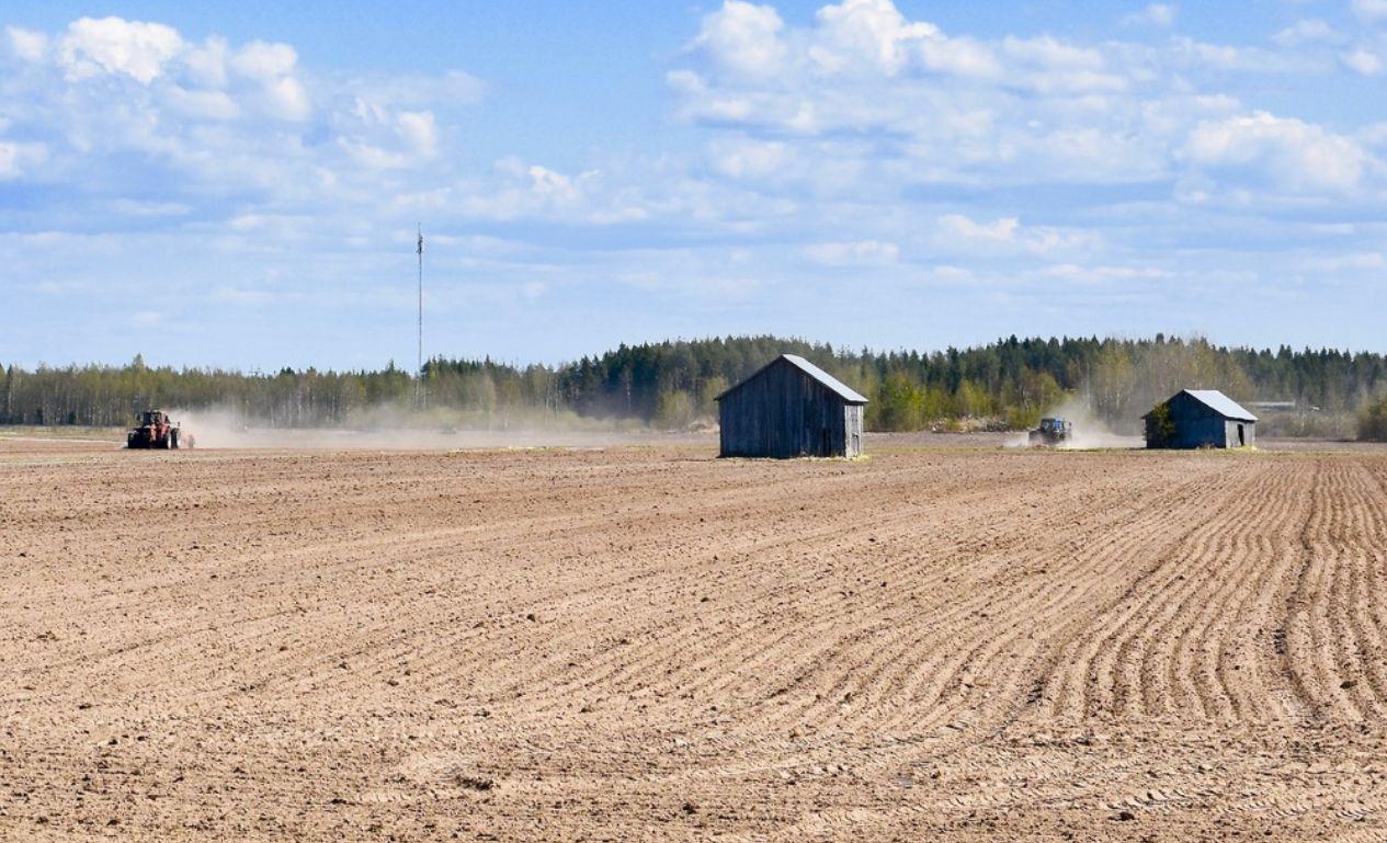 en åker, hus och traktorer