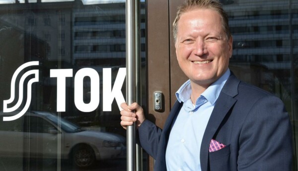 Man i kavaj håller i dörrhandtag