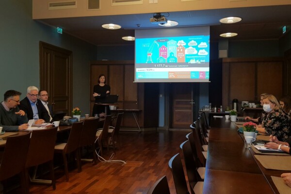 Kvinna håller presentation i sal med publik