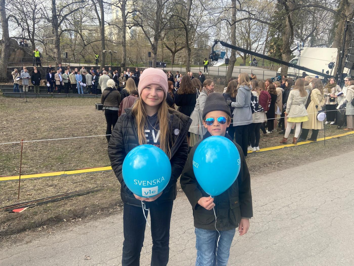 Två barn med ballonger.