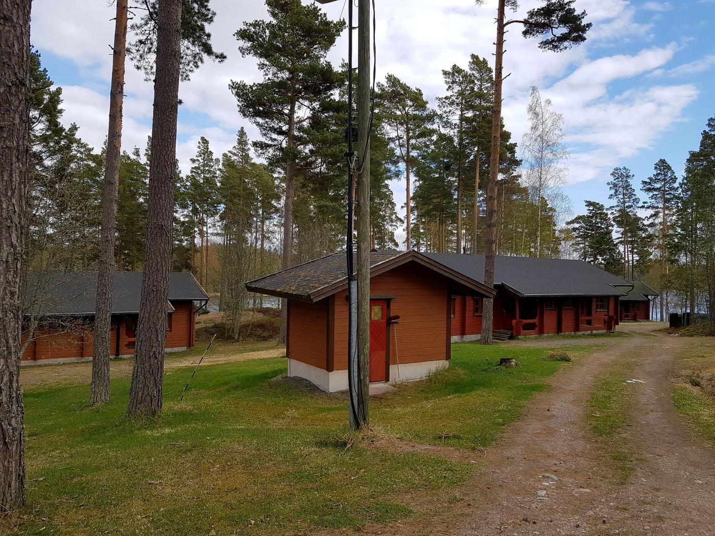 tre stugor i skogsområde vid havet