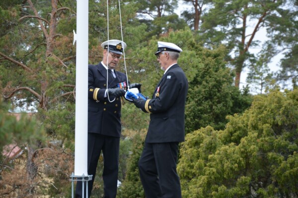 två officerare hissar en flagga