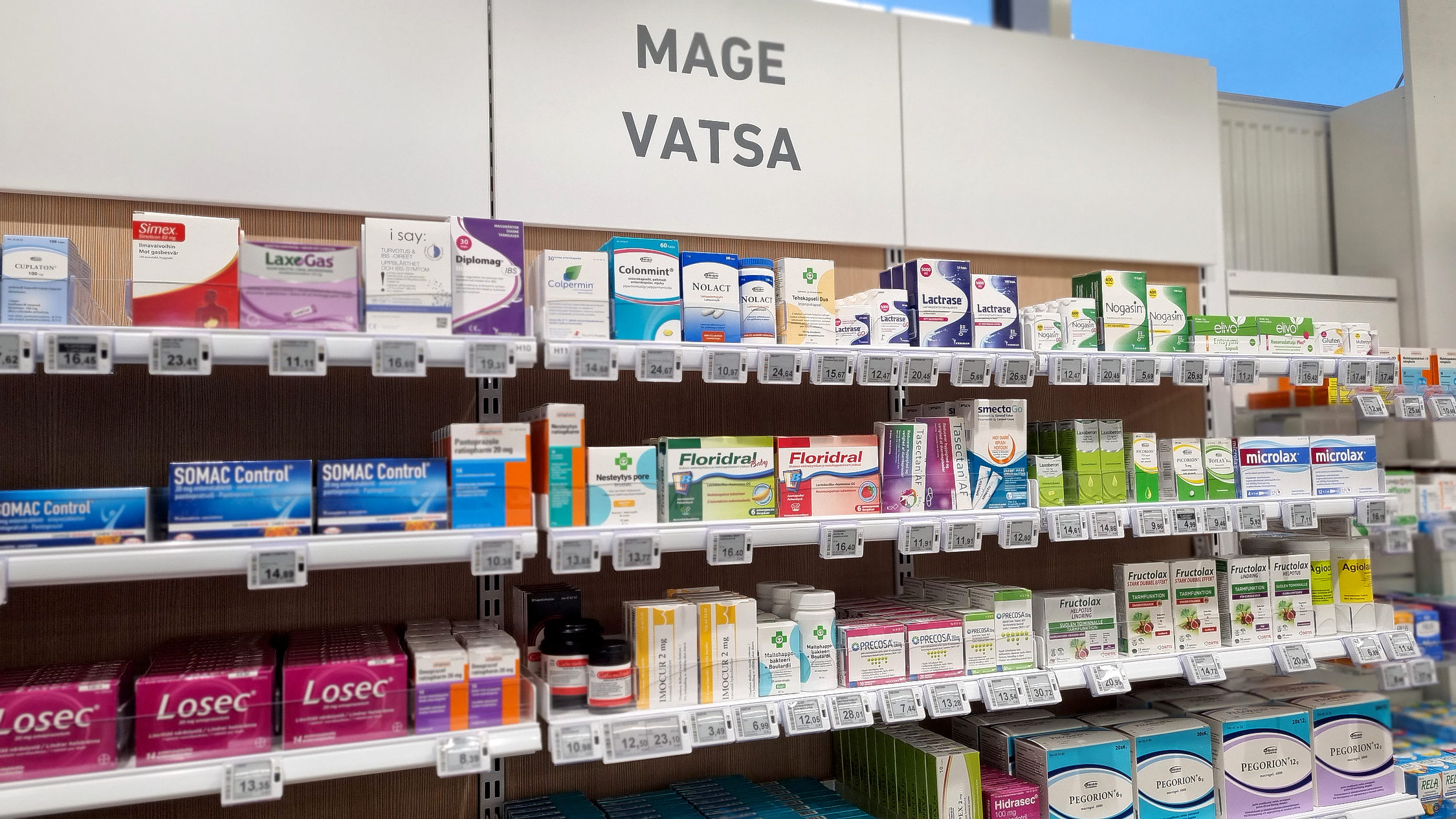 Hylla med receptfria egenvårdsmediciner på apotek.