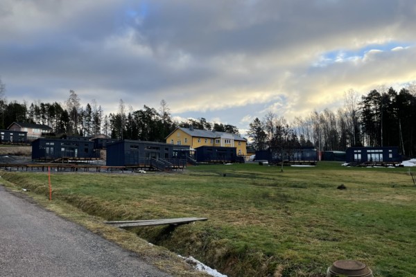 gult stenhus lite skymt av små gråa hus