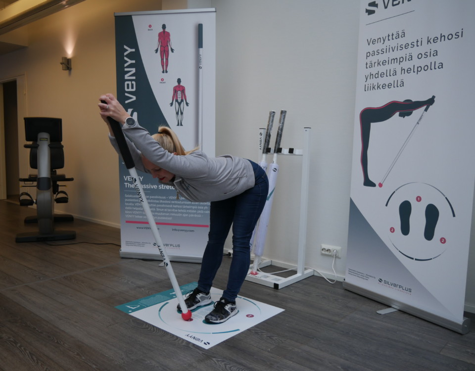 Kvinna använder stretchningsstång och lutar sig framåt.
