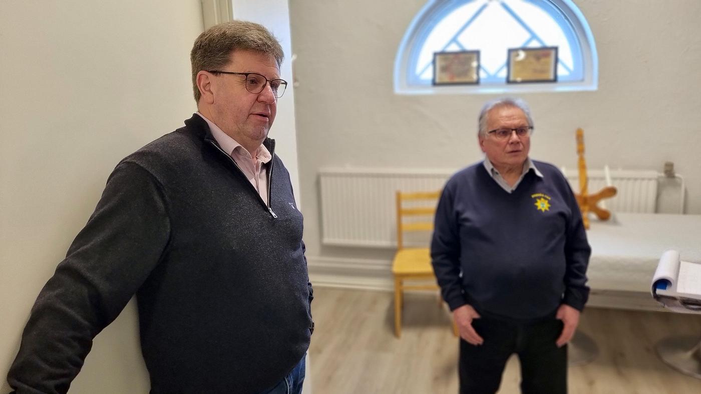 Två män i ljust rum.