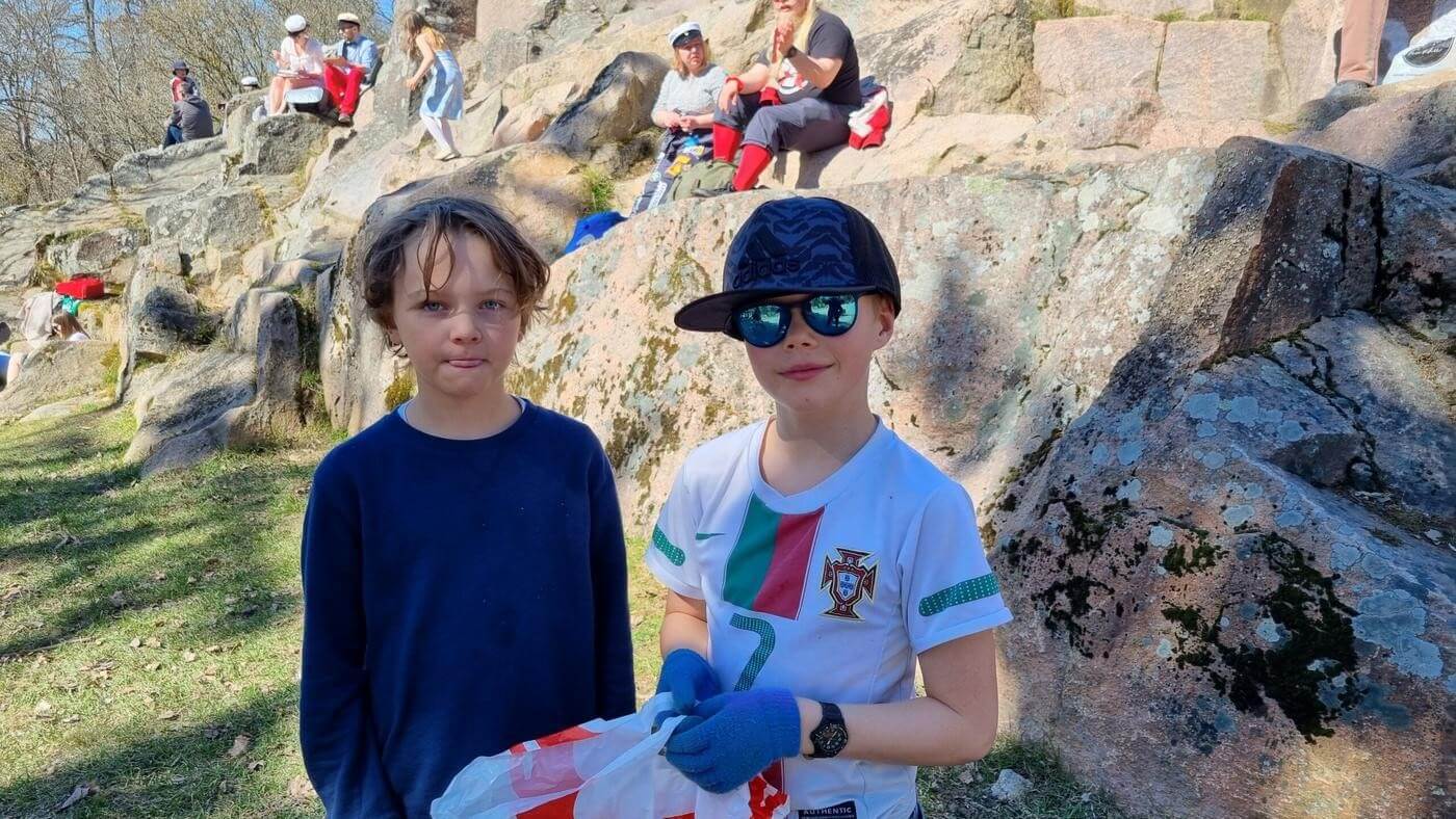 Två pojkar mot en sten