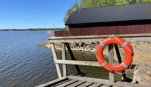 röd byggnad vid vatten fotad från en brygga